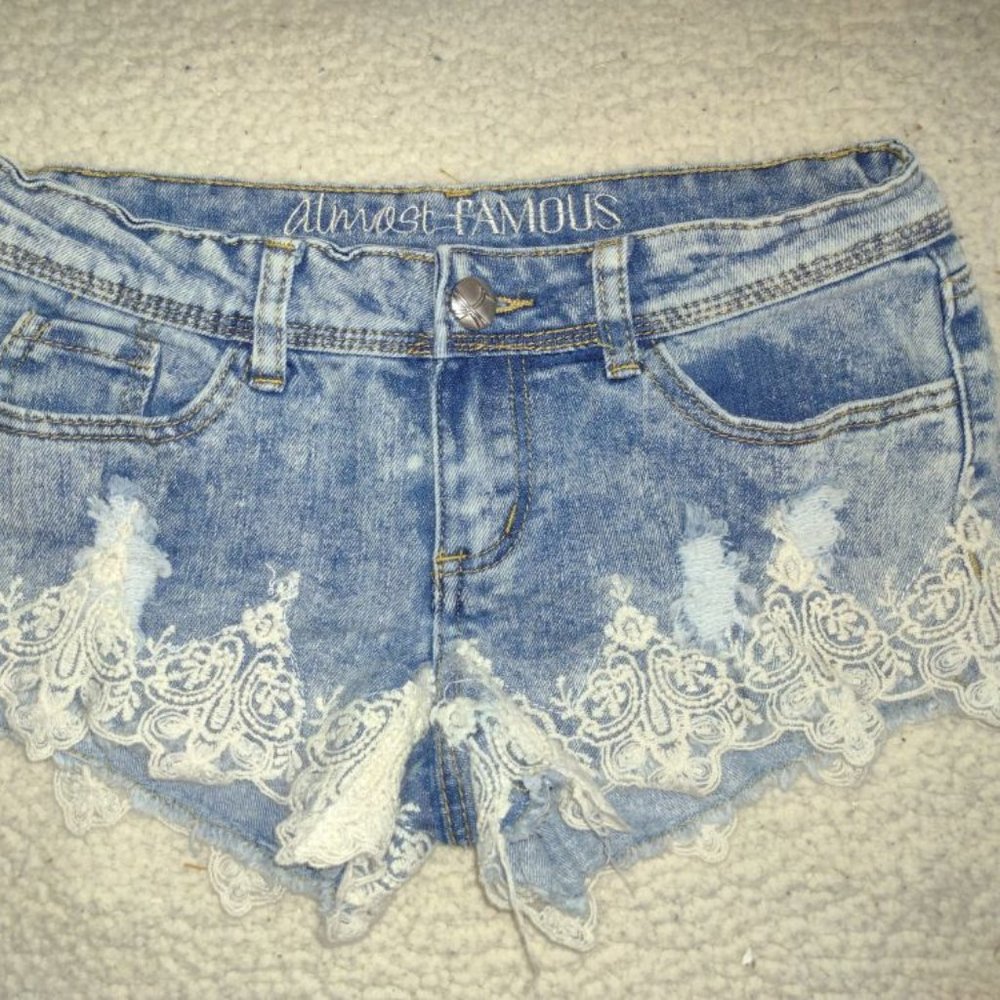 Almost Famous stylish pair of ladies' destress jeans with white lace in size 1